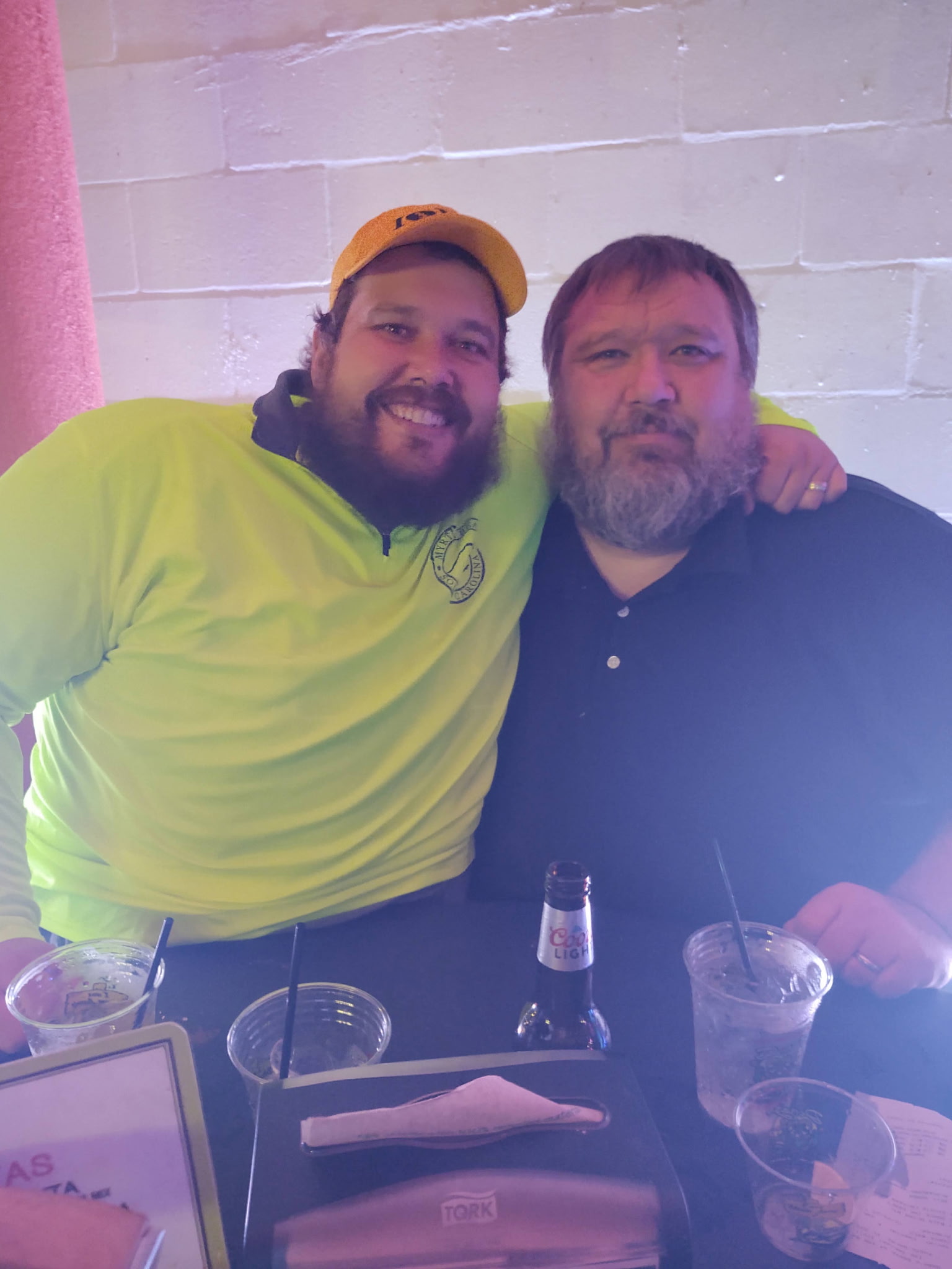 Two family members posing together at a restaurant table